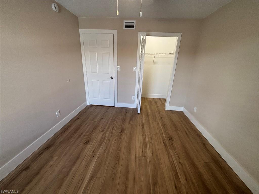 5319 Summerlin Road, Unit 1916 Fort Myers, FL 33919 - Photo 6 of 8 a view of a room with wooden floor and a window