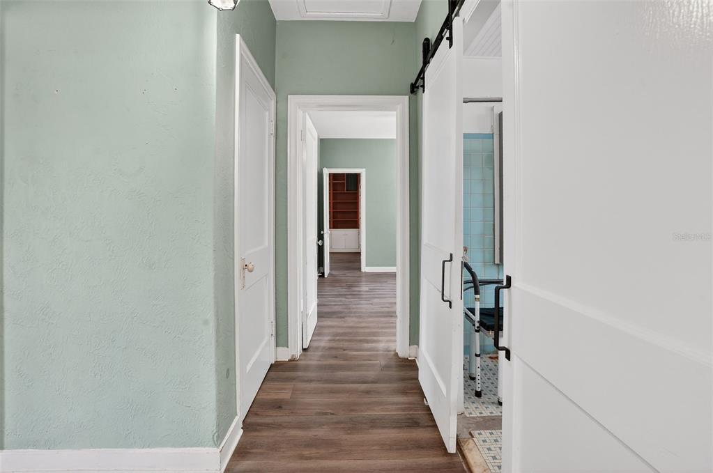 7970 Bannon Fish Camp Road Haines City, FL 33844 - Photo 15 of 73 a view of a hallway with wooden floor and staircase