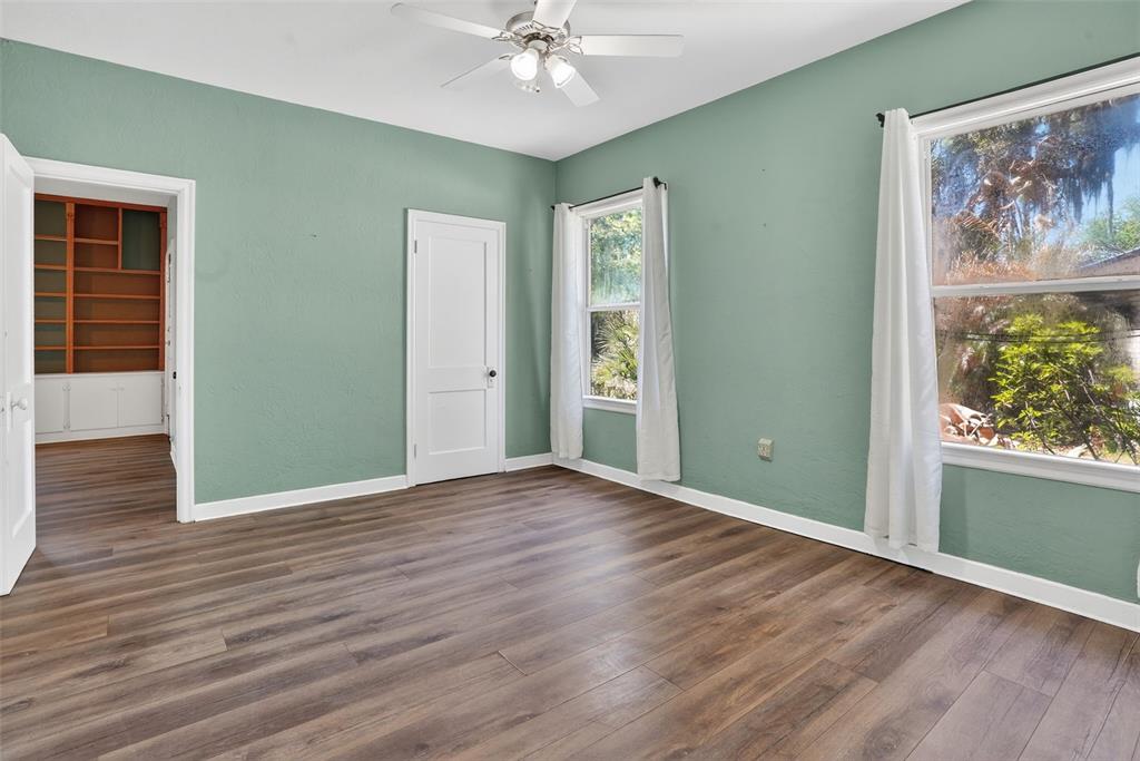 7970 Bannon Fish Camp Road Haines City, FL 33844 - Photo 16 of 73 a view of an empty room with wooden floor and a window