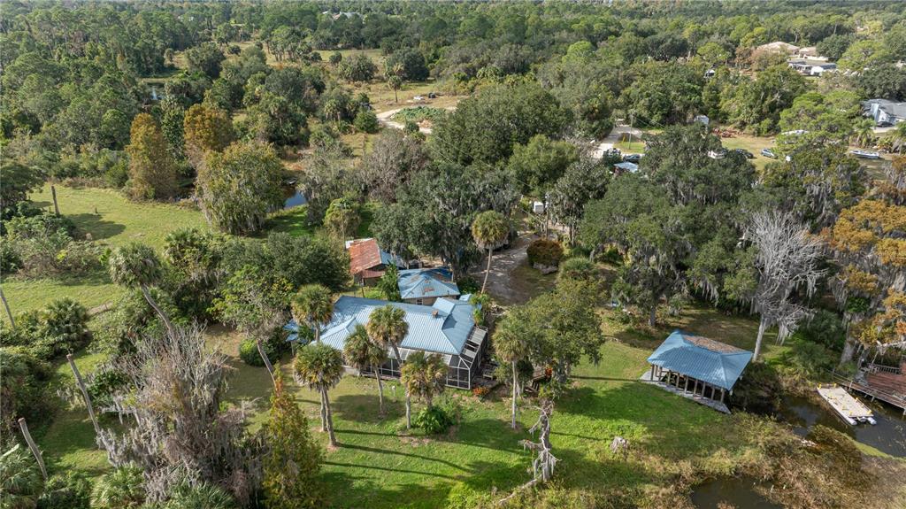 7970 Bannon Fish Camp Road Haines City, FL 33844 - Photo 19 of 73 an aerial view of residential house with swimming pool and green space