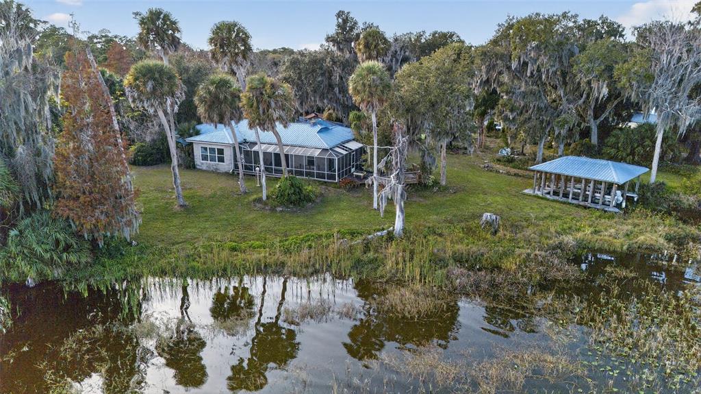 7970 Bannon Fish Camp Road Haines City, FL 33844 - Photo 24 of 73 a backyard of a house with lots of green space and fountain