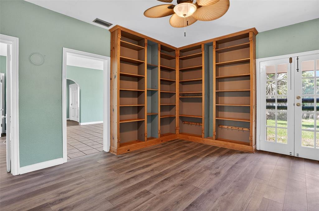 7970 Bannon Fish Camp Road Haines City, FL 33844 - Photo 4 of 73 a view of an empty room with a window and wooden floor