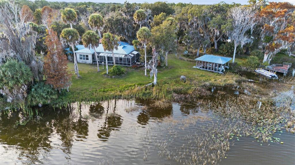 7970 Bannon Fish Camp Road Haines City, FL 33844 - Photo 48 of 73 a view of a lake with houses in front of statue
