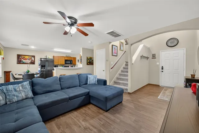 a living room with furniture and wooden floor