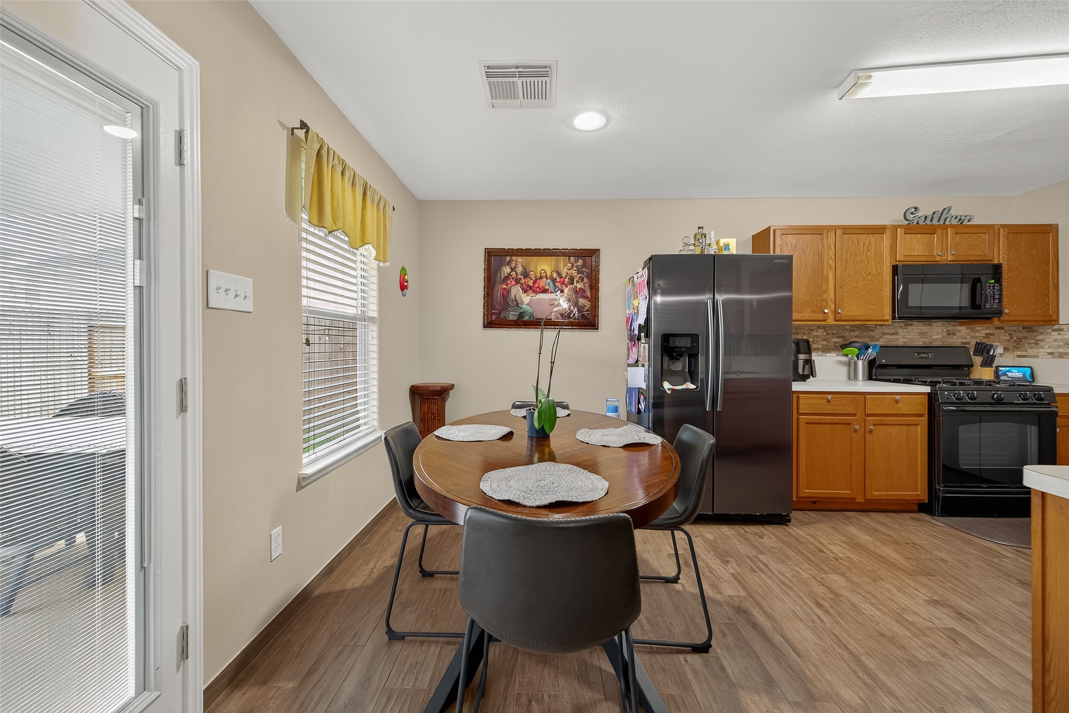 8311 Tartan Court Rosharon, TX 77583 - Photo 14 of 48 a view of a dining room with furniture and wooden floor