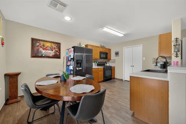 a view of a dining room with furniture and a kitchen