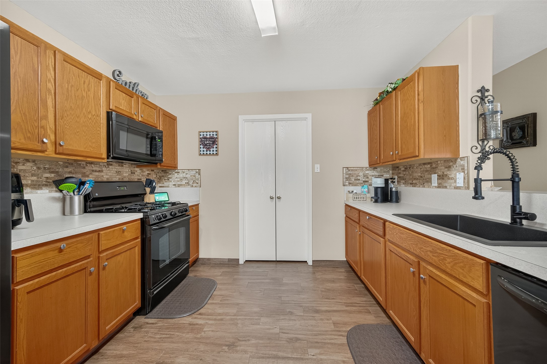 8311 Tartan Court Rosharon, TX 77583 - Photo 17 of 48 a kitchen with stainless steel appliances granite countertop a stove a sink and a refrigerator