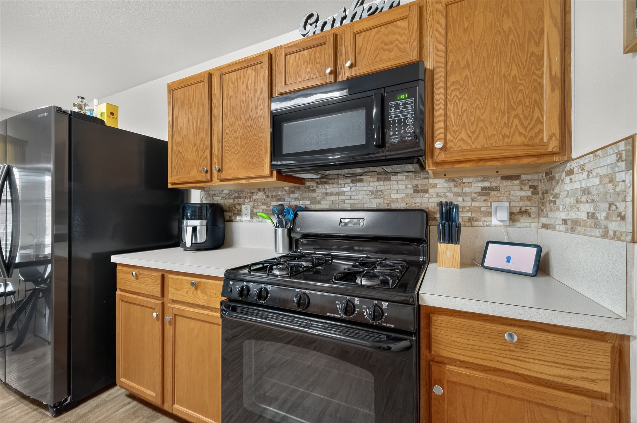 8311 Tartan Court Rosharon, TX 77583 - Photo 21 of 48 a kitchen with stainless steel appliances granite countertop a stove microwave refrigerator and sink