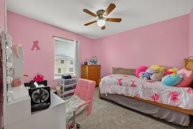 a bedroom with pink walls and a bed