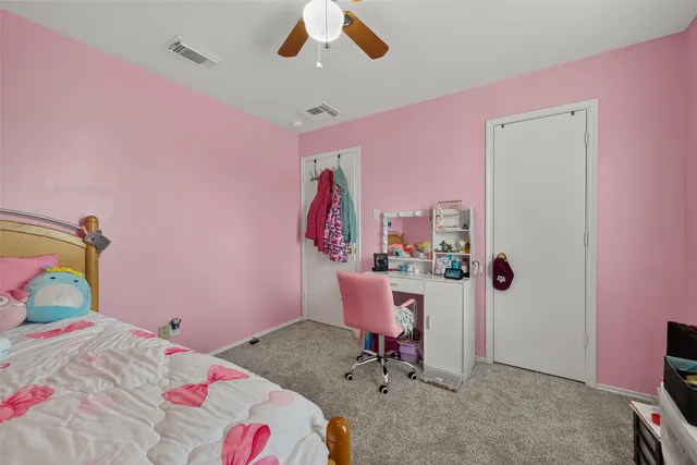 a bedroom with a bed and a desk