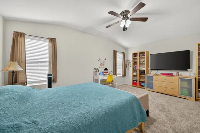 a bedroom with furniture and a flat screen tv