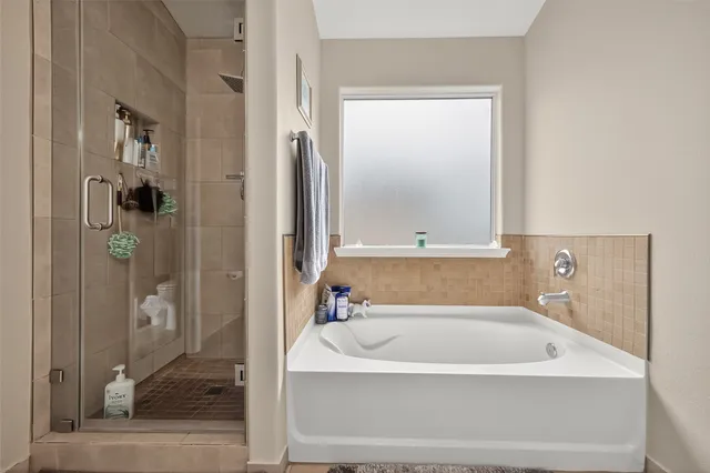 a bathroom with a bathtub and shower
