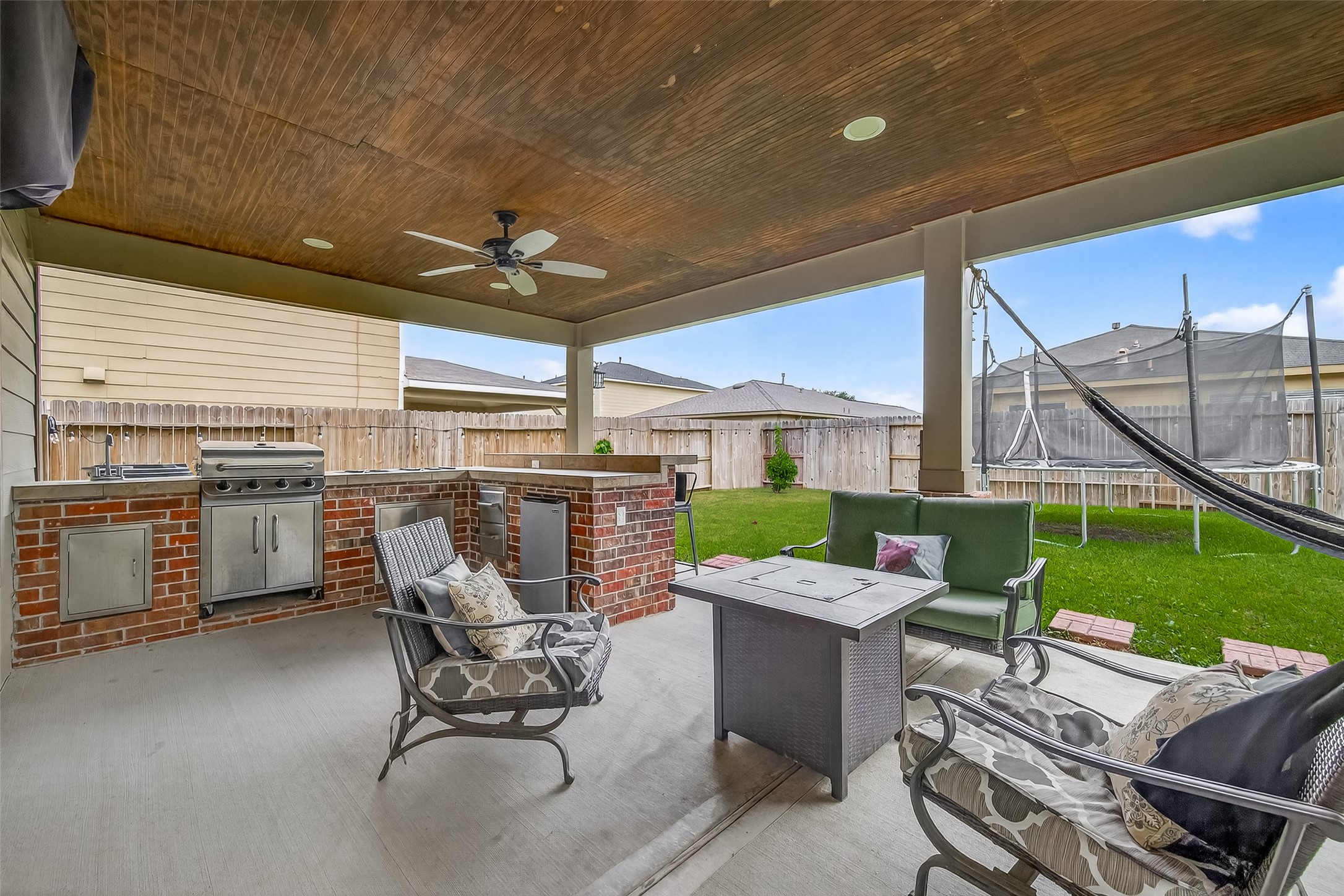 8311 Tartan Court Rosharon, TX 77583 - Photo 41 of 48 a view of a patio with table and chairs potted plants with wooden floor