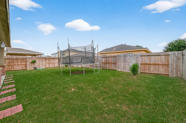 a view of a house with a backyard