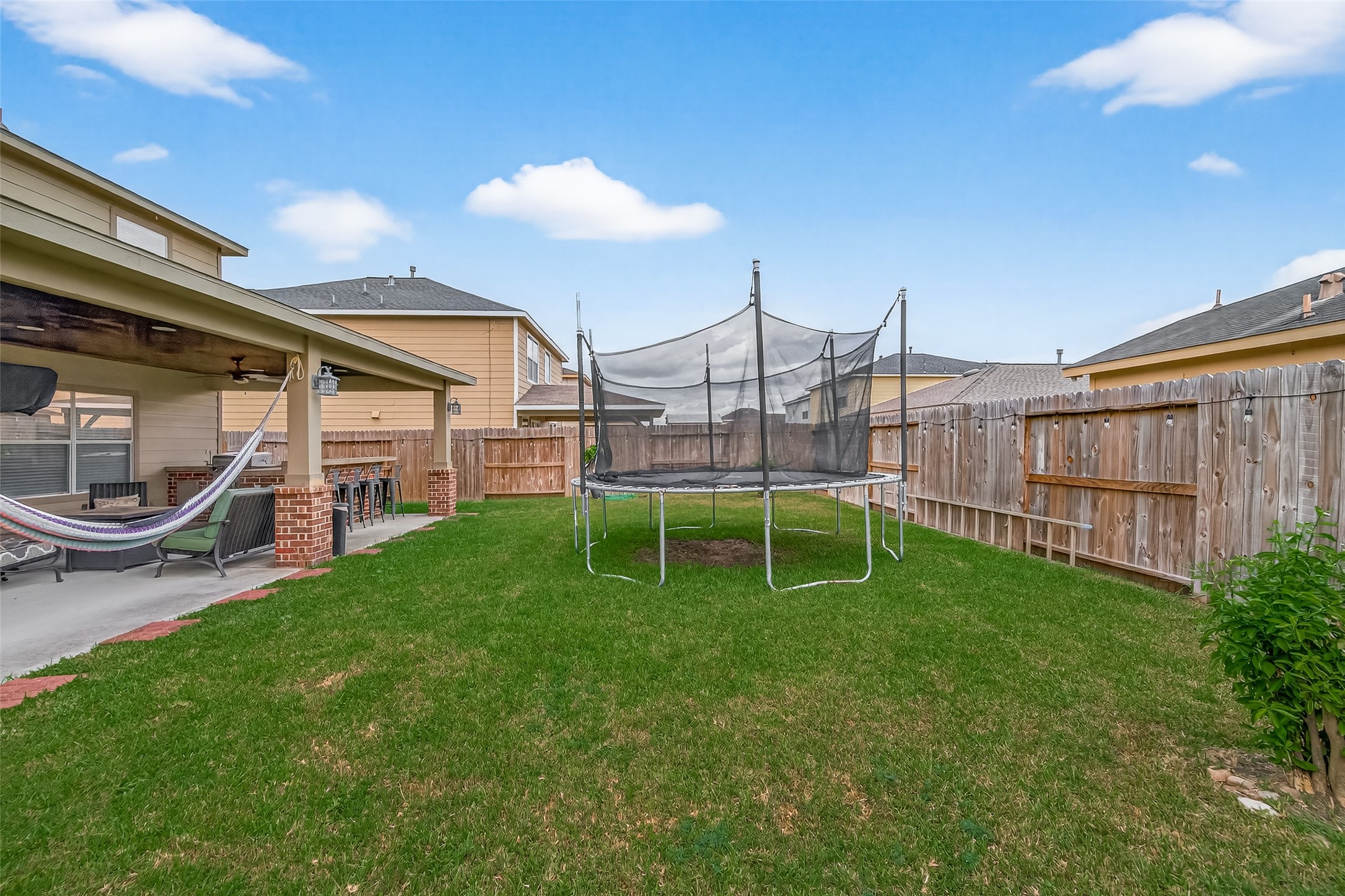 8311 Tartan Court Rosharon, TX 77583 - Photo 45 of 48 a view of a chair and table in backyard of the house