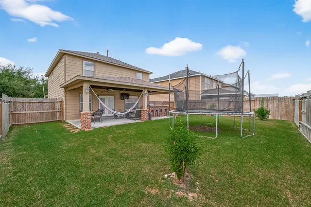 a view of a house with a backyard