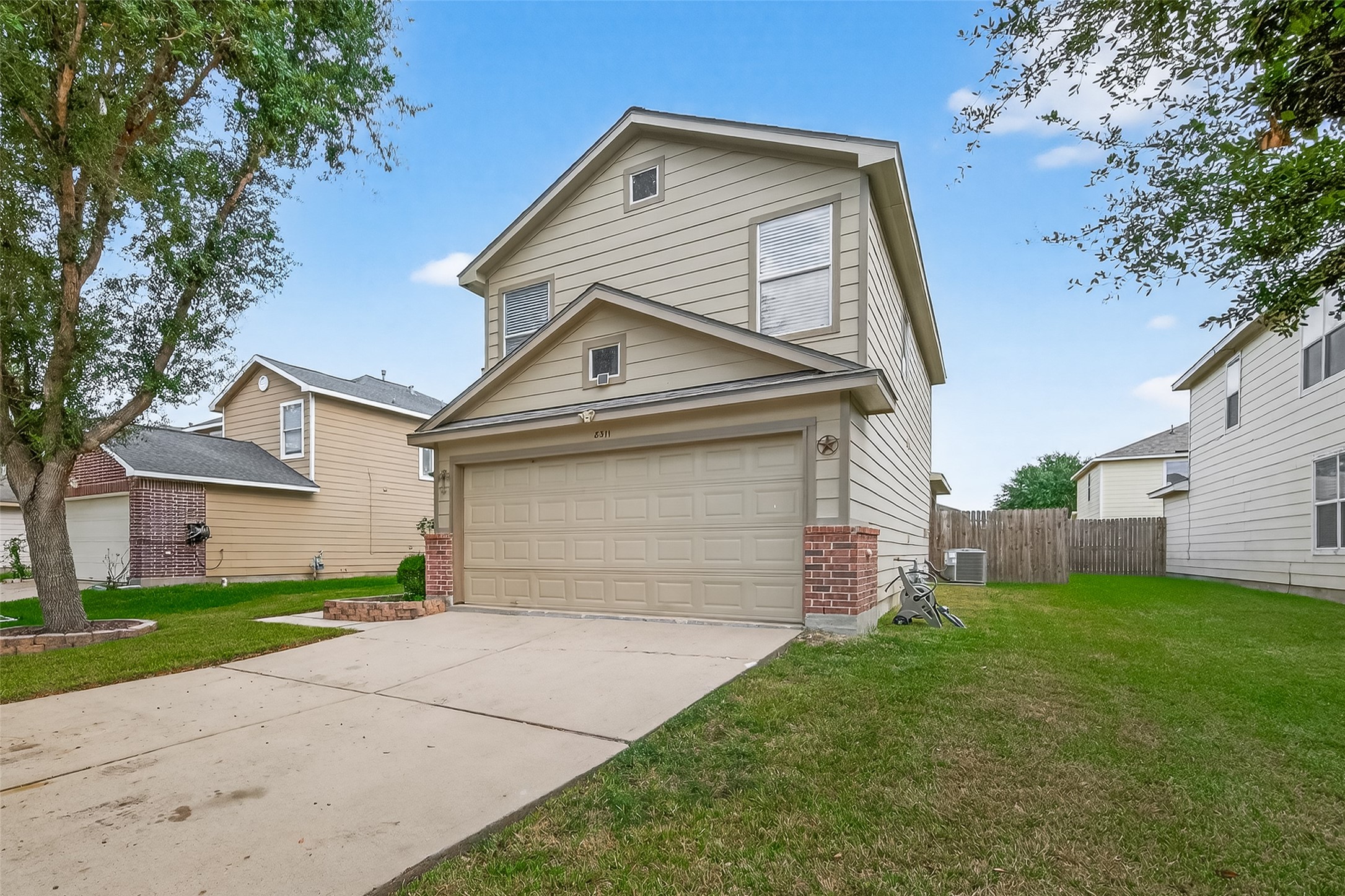 8311 Tartan Court Rosharon, TX 77583 - Photo 5 of 48 a front view of a house with a yard and garage
