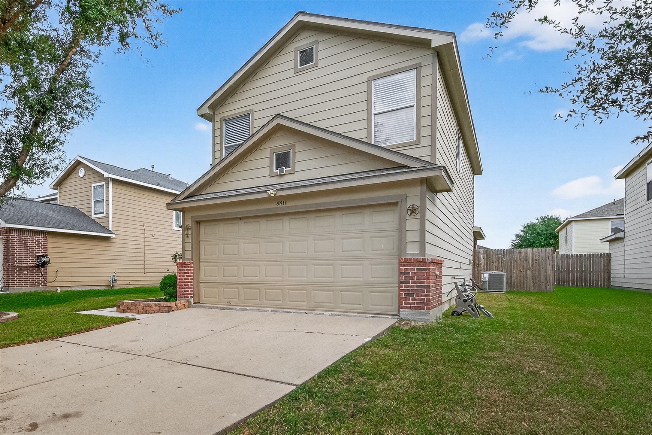 8311 Tartan Court Rosharon, TX 77583 - Photo 6 of 48 a front view of a house with a yard and garage