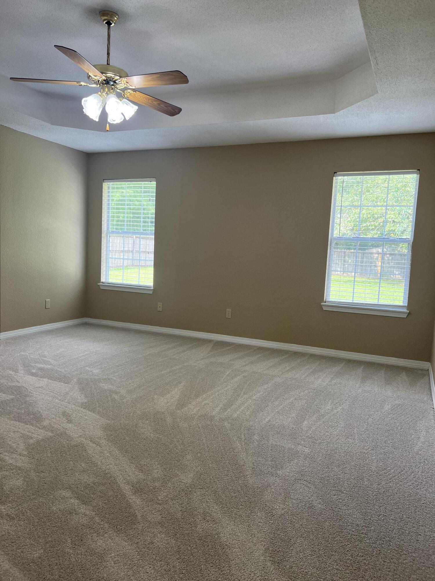 159 Nun Drive Crestview, FL 32536 - Photo 12 of 27 an empty room with windows and chandelier fan