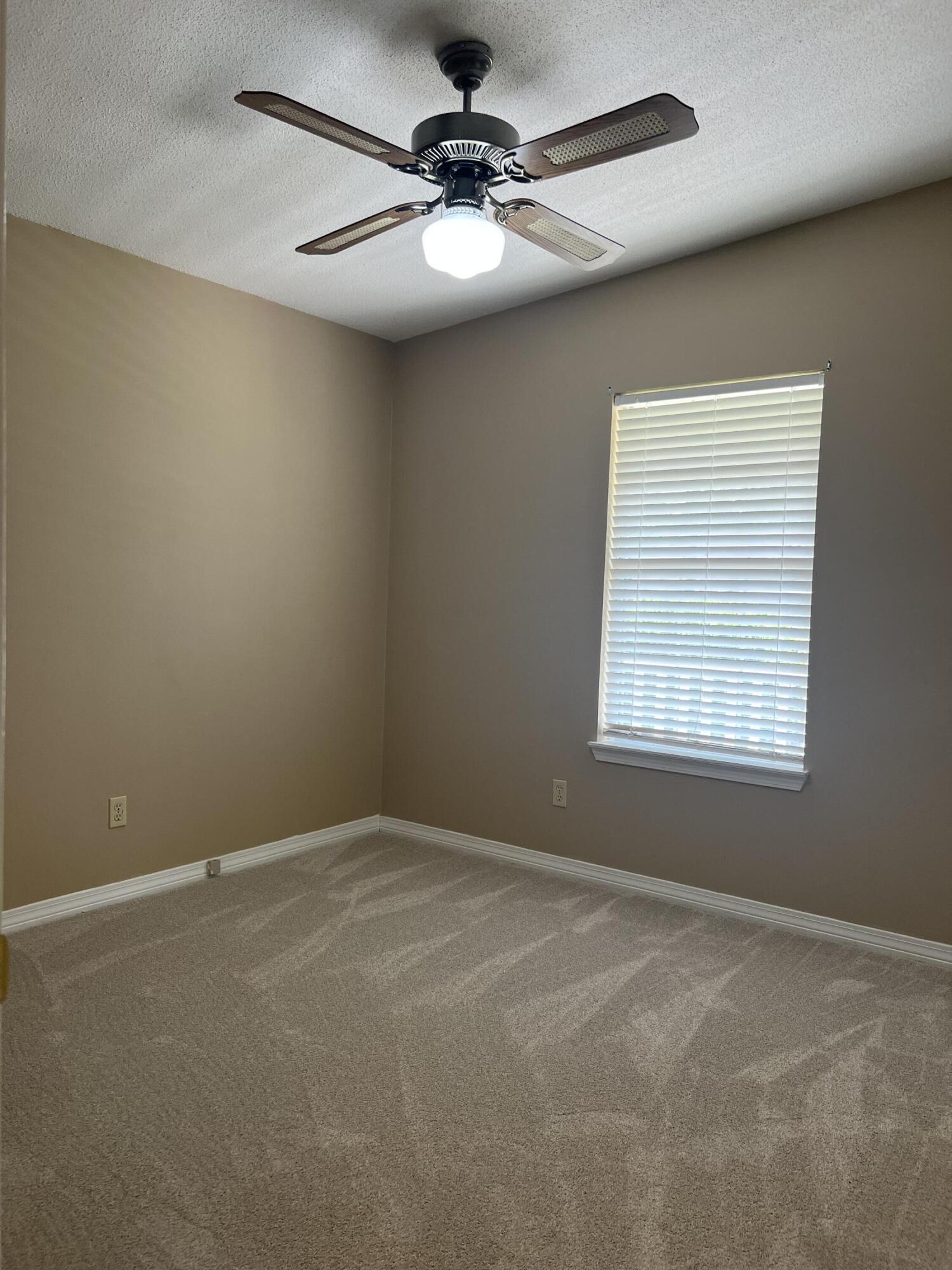 159 Nun Drive Crestview, FL 32536 - Photo 18 of 27 en empty room with a window and a ceiling fan