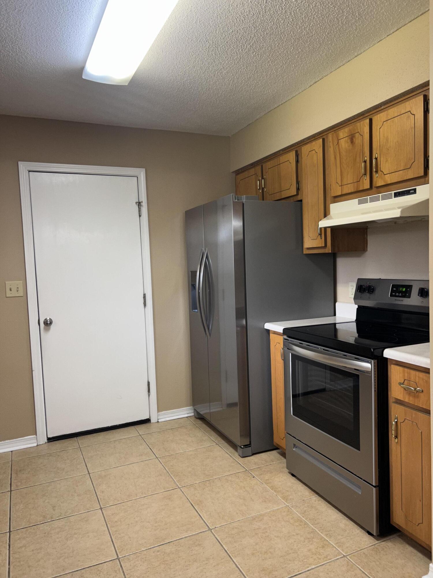 159 Nun Drive Crestview, FL 32536 - Photo 7 of 27 a kitchen with stainless steel appliances granite countertop a refrigerator a stove and a sink with cabinets