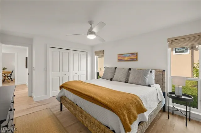 a spacious bedroom with a bed and a chandelier