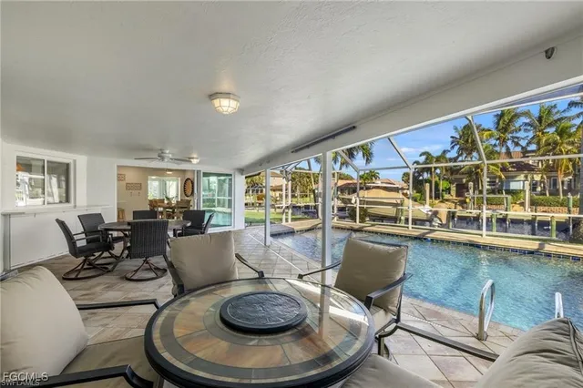 a living room with fireplace furniture and a large window