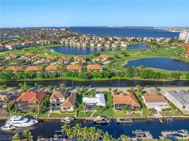 an aerial view of a city with lots of residential buildings lake and ocean view