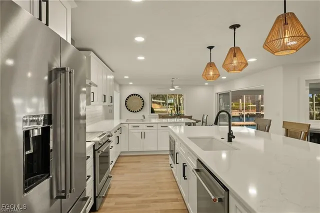 a kitchen with stainless steel appliances a sink cabinets and refrigerator