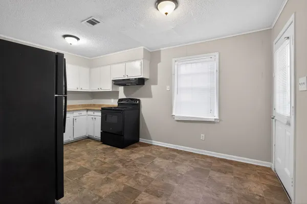 a kitchen with stainless steel appliances granite countertop a refrigerator a stove a sink and a microwave