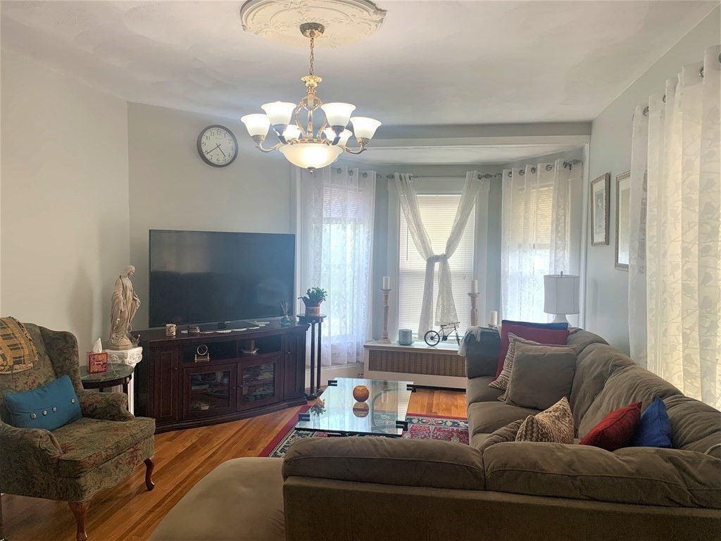35 5th Street Medford, MA 02155 - Photo 11 of 42 a living room with furniture a ceiling fan and a window