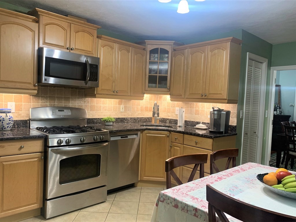 35 5th Street Medford, MA 02155 - Photo 13 of 42 a kitchen with a stove a sink and a microwave