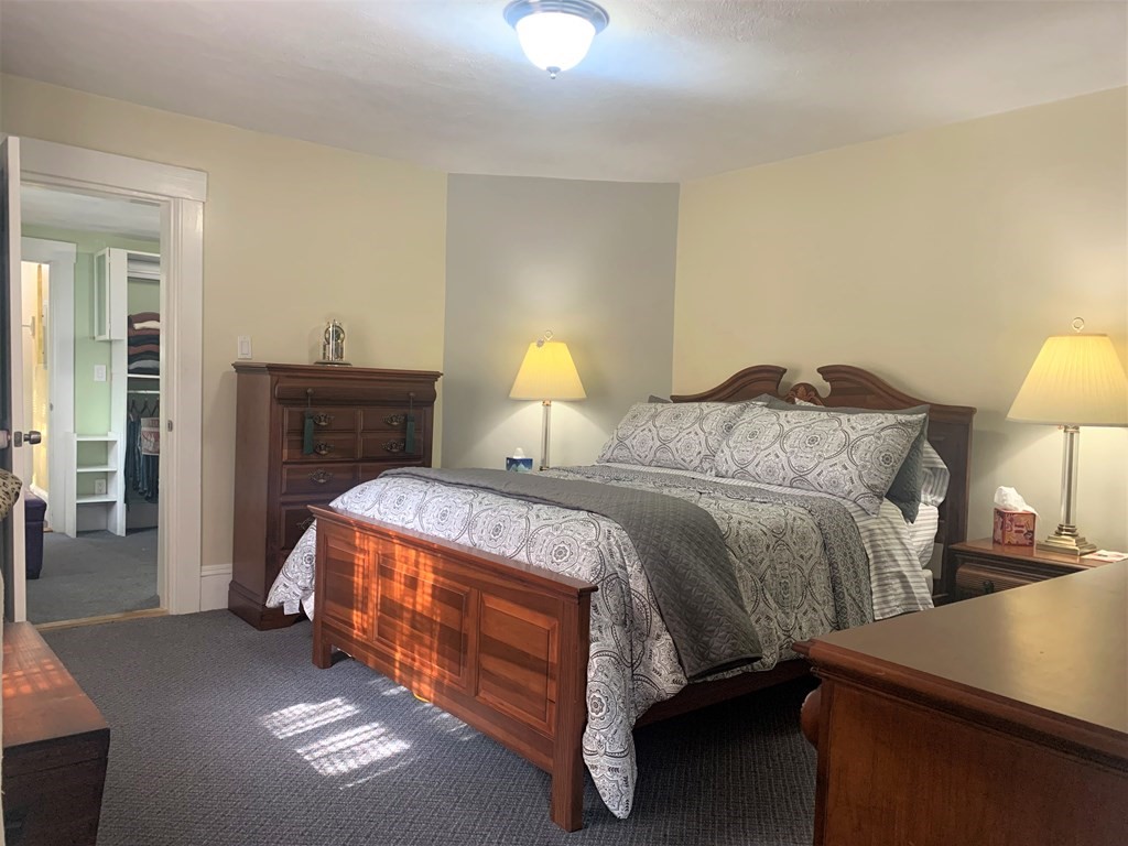 35 5th Street Medford, MA 02155 - Photo 22 of 42 a bedroom with a bed and a lamp