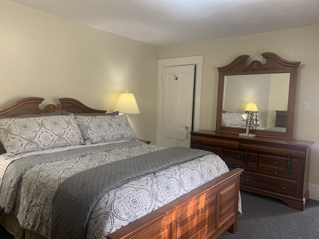 35 5th Street Medford, MA 02155 - Photo 24 of 42 a bedroom with a bed and a mirror on dresser
