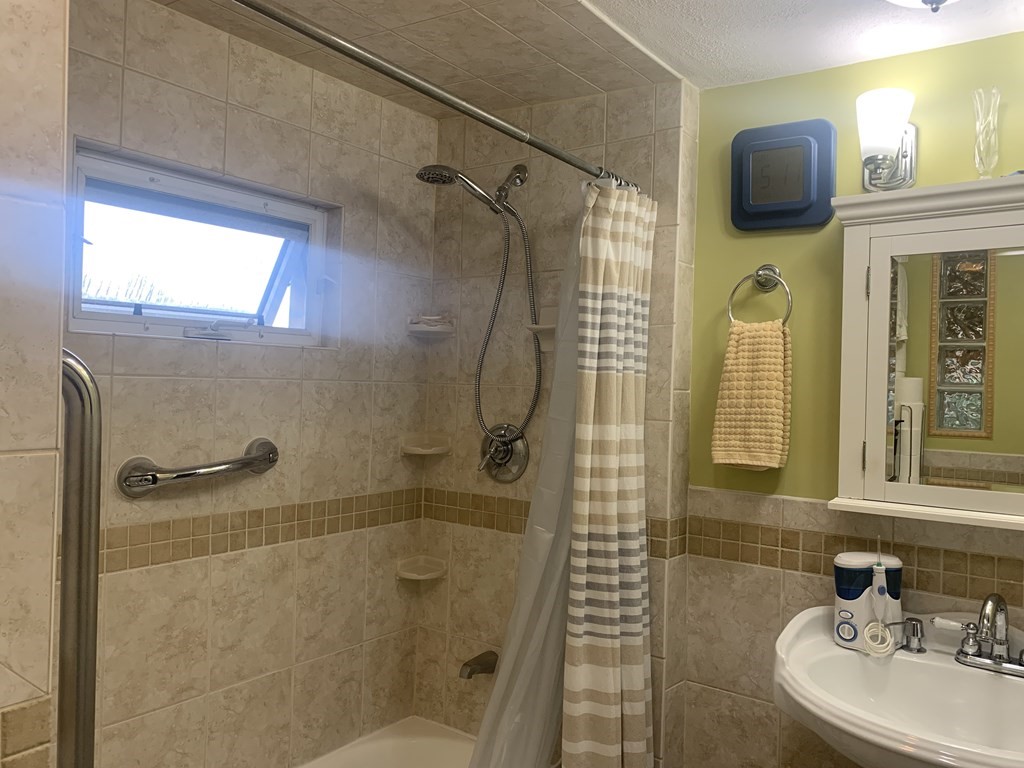 35 5th Street Medford, MA 02155 - Photo 28 of 42 a bathroom with a shower and a sink