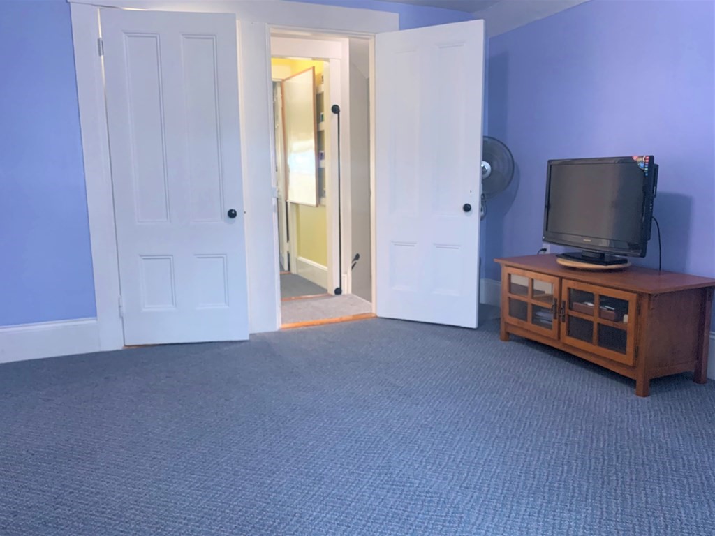 35 5th Street Medford, MA 02155 - Photo 30 of 42 a living room with furniture and a flat screen tv