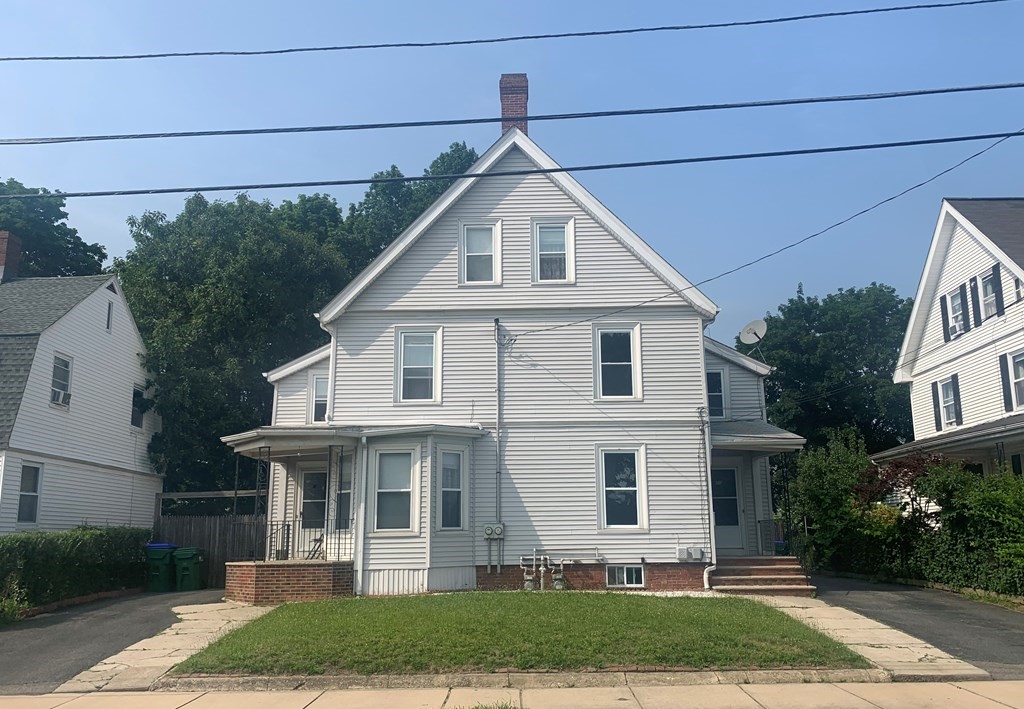 35 5th Street Medford, MA 02155 - Photo 3 of 42 a view of a white house next to yard
