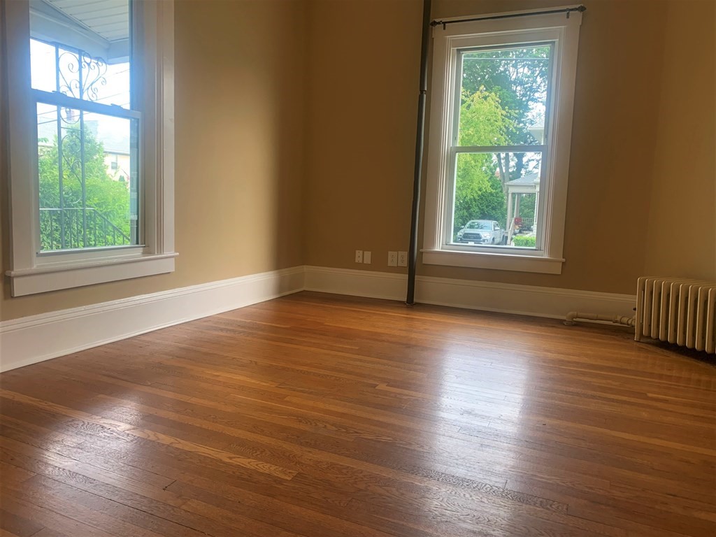 35 5th Street Medford, MA 02155 - Photo 32 of 42 an empty room with wooden floor and windows
