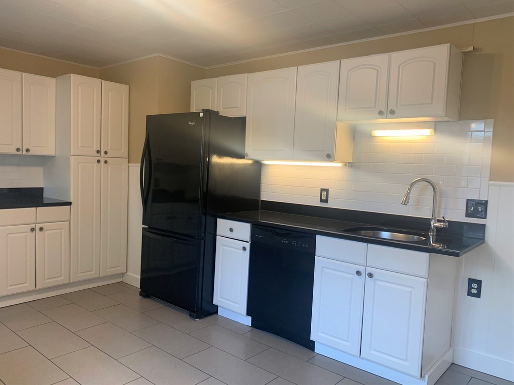 35 5th Street Medford, MA 02155 - Photo 34 of 42 a kitchen with a sink and refrigerator