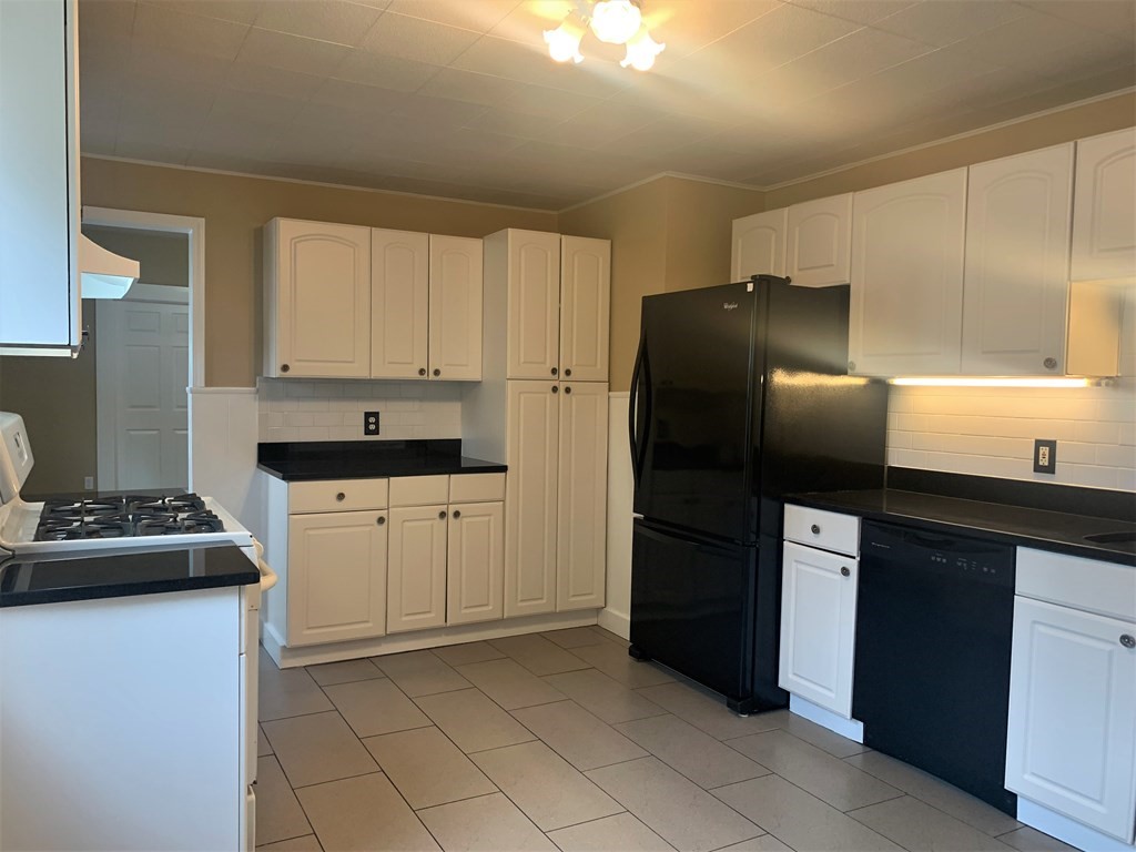 35 5th Street Medford, MA 02155 - Photo 36 of 42 a kitchen with a refrigerator and cabinets