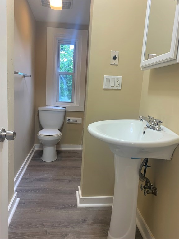 35 5th Street Medford, MA 02155 - Photo 37 of 42 a bathroom with a sink toilet and a window