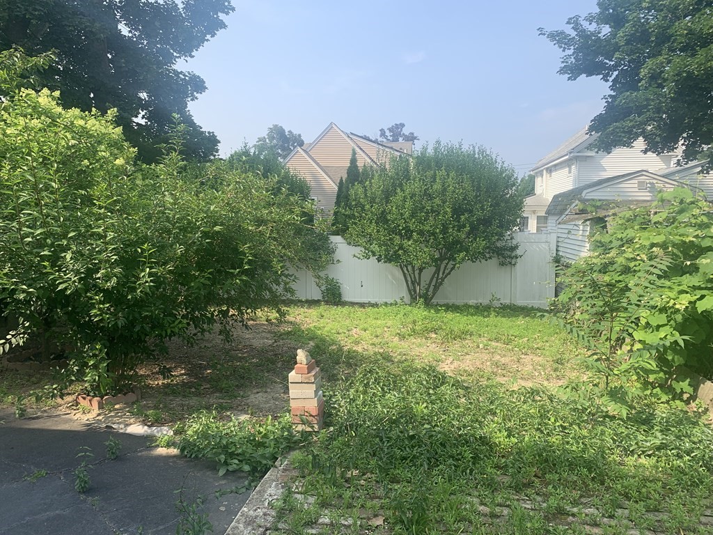 35 5th Street Medford, MA 02155 - Photo 4 of 42 a backyard of a house with lots of green space and garden