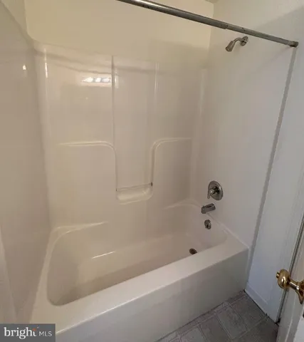 an empty room with windows and ceiling fan view