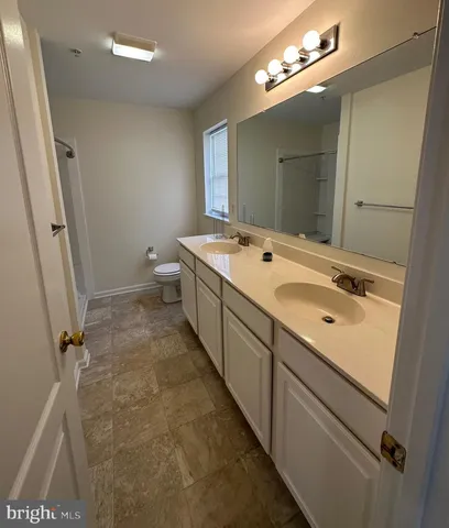 a view of a kitchen with a sink cabinets and wooden floor