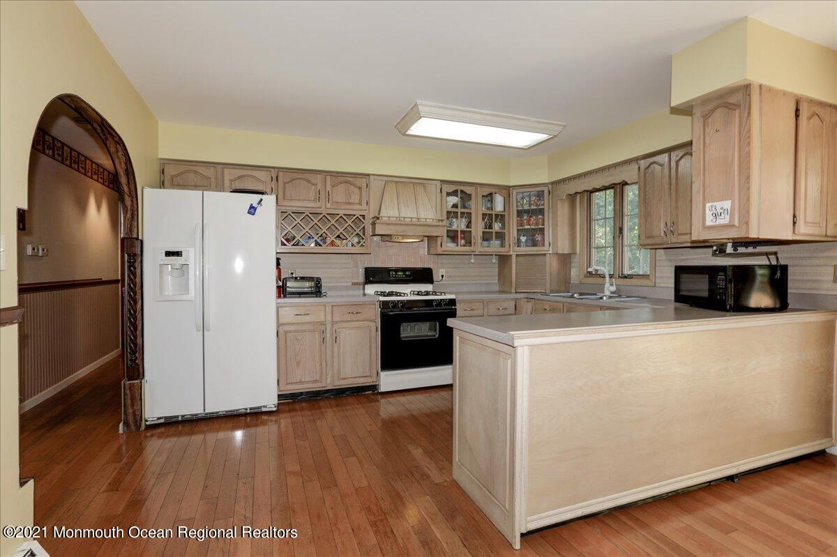41 Haines Street Lanoka Harbor, NJ 08734 - Photo 14 of 43 a kitchen with stainless steel appliances a refrigerator a stove a sink and a hard wood floor
