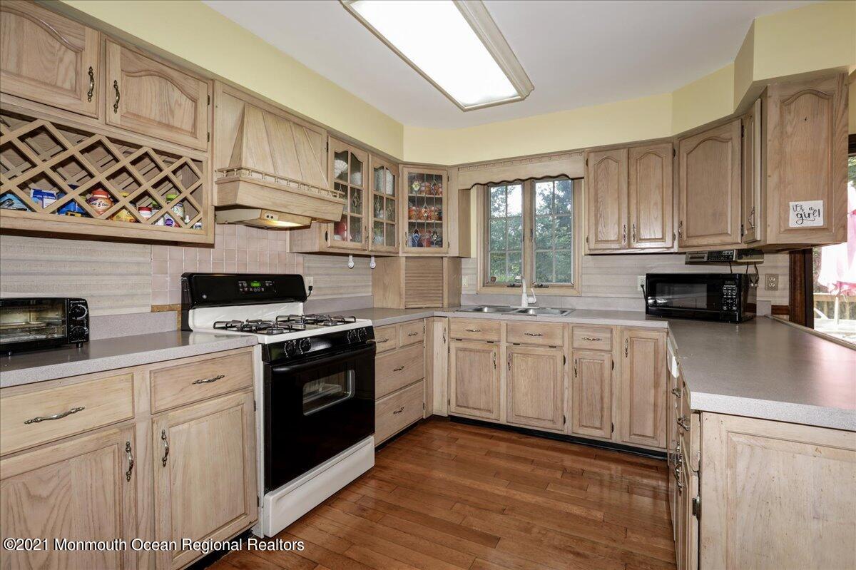 41 Haines Street Lanoka Harbor, NJ 08734 - Photo 16 of 43 a kitchen with granite countertop a stove sink and cabinets