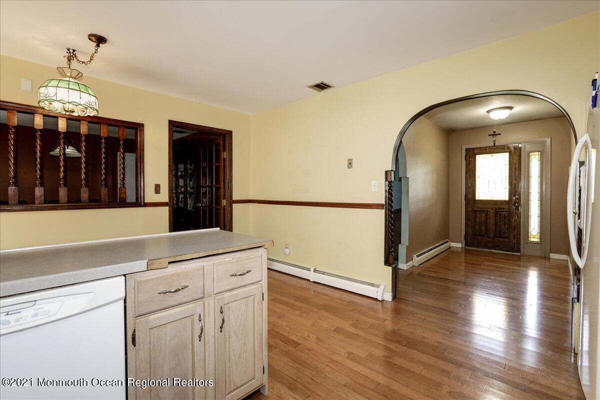 41 Haines Street Lanoka Harbor, NJ 08734 - Photo 17 of 43 a hallway with a sink and a mirror