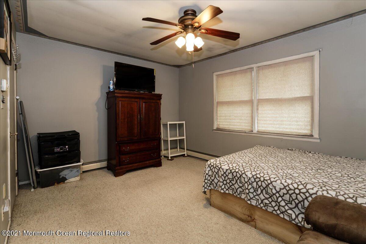 41 Haines Street Lanoka Harbor, NJ 08734 - Photo 22 of 43 a bedroom with a bed and a tv