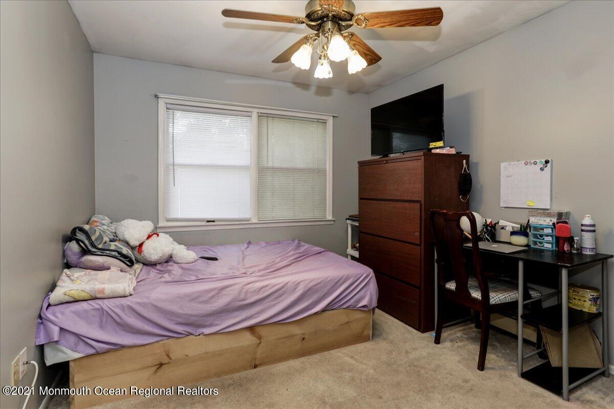 41 Haines Street Lanoka Harbor, NJ 08734 - Photo 26 of 43 a bedroom with a bed and a flat tv screen on dresser