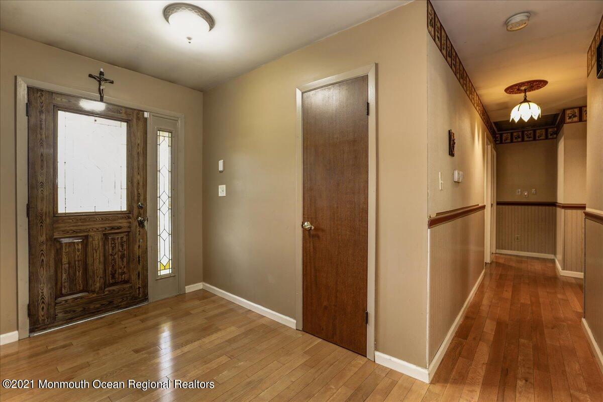 41 Haines Street Lanoka Harbor, NJ 08734 - Photo 6 of 43 a view of a hallway with wooden floor and a bathroom